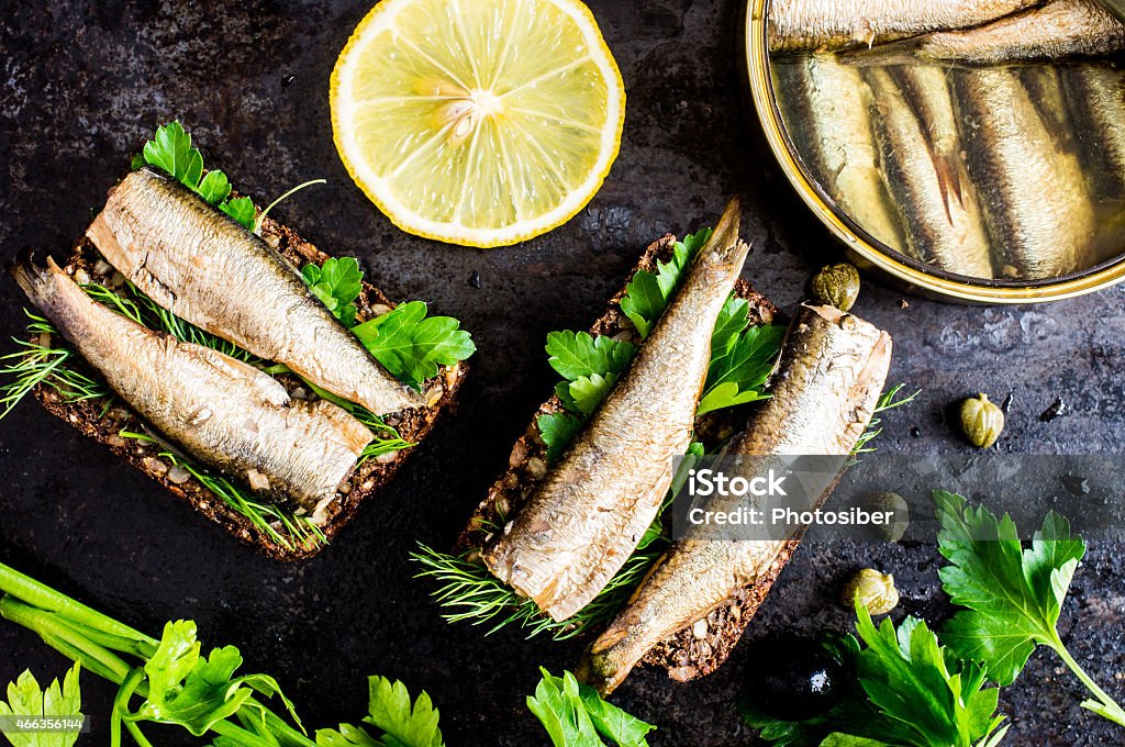 A sandwich with sardines and cilantro Sandwich with sardines, sprats with parsley and dill 2015 Stock Photo