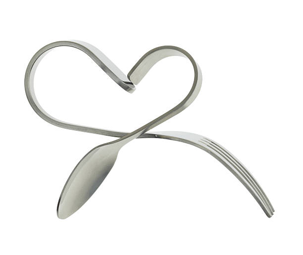 istock Fork and spoon bent in shape of heart isolated 466359019