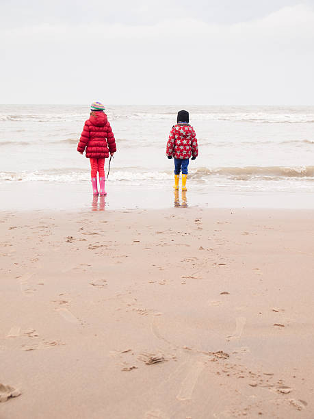 istock small boy and girl on the beach 466359091