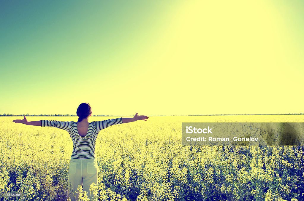 woman in the field woman standing in the field Grass Stock Photo