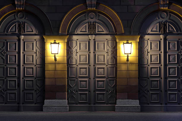 Two lanterns illuminating historic doors, Germany