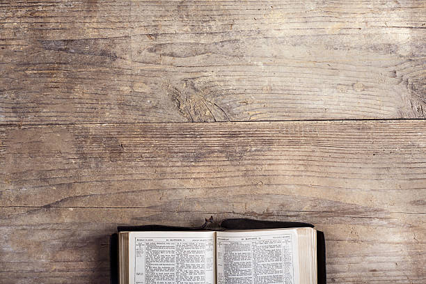 biblia sobre un escritorio de madera - biblia fotografías e imágenes de stock