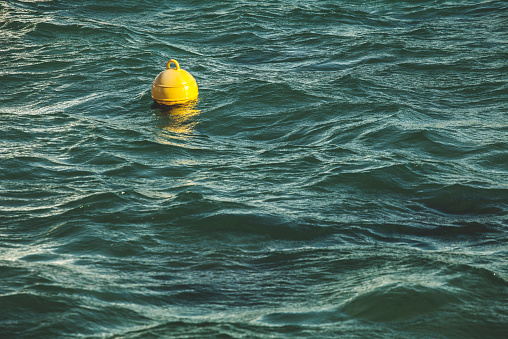 Yellow bouy by the stormy sea