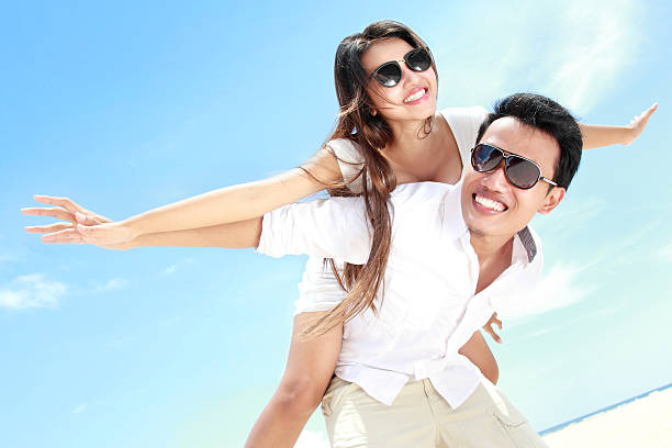 istock romantic young couple on the beach having fun 466367820