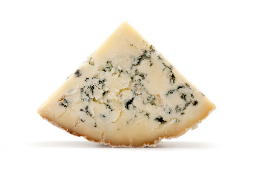 Slice of blue Stilton cheese on a white background
