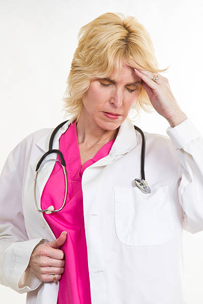istock Caucasian blond medical professional having headache 466369709