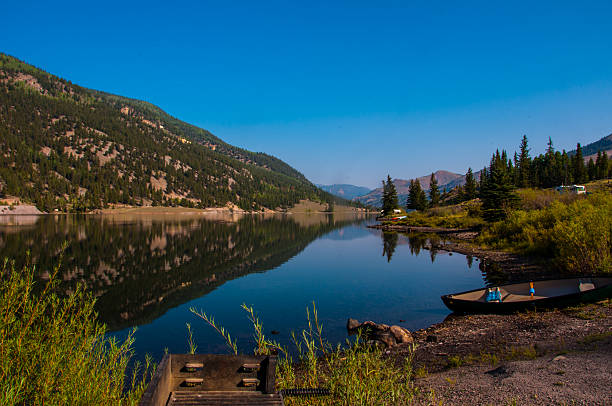 istock Colorado Lake Reflection Canoe Grill and Mountains 466373498
