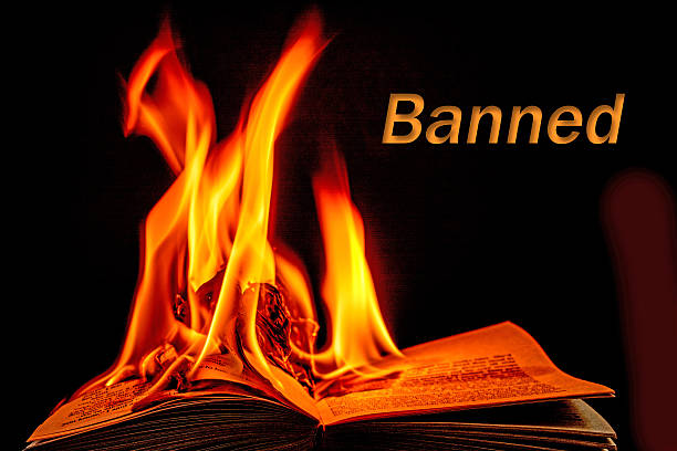istock Burning book with the word Banned- black background. 466374032