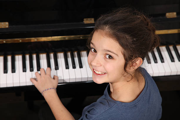 istock Young girl smiling during a piano lesson 466375231