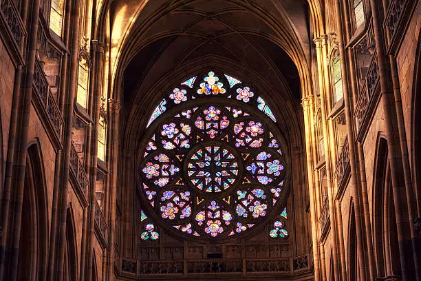 Church interior - view on circle stained glass window (rosette). Saint Vitus Cathedral in Prague, Czech Republic.