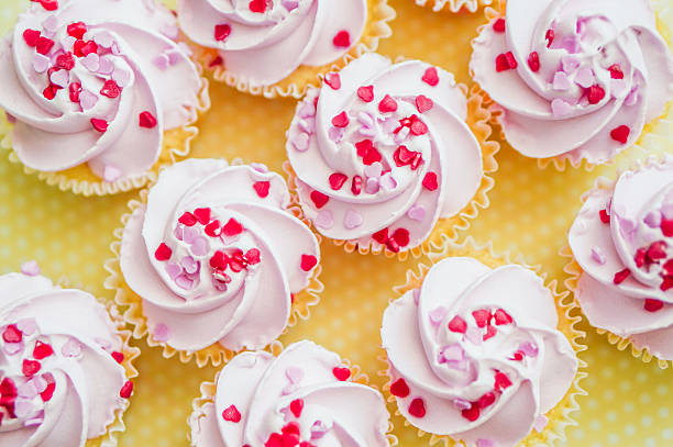 istock Cupcakes with pink cream and heart sprinkles 466376475