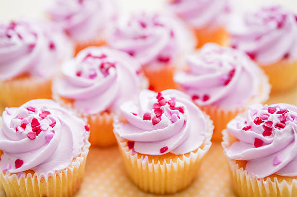 istock Cupcakes with pink cream and heart sprinkles 466376481