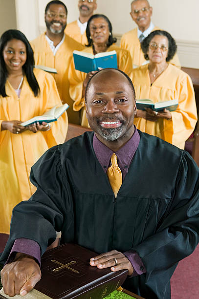 istock Preacher With Bible While Choir Standing In Background At Church 466376555