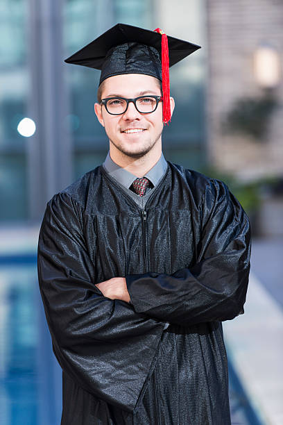 istock Young man in graduation cap and gown 466376650