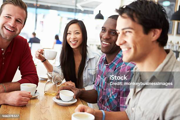 Group Of Friends Meeting In Coffee Shop Stock Photo - Download Image Now - 20-29 Years, Adult, Adults Only