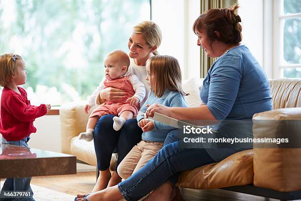 Health Visitor Talking To Mother With Young Children Stock Photo - Download Image Now