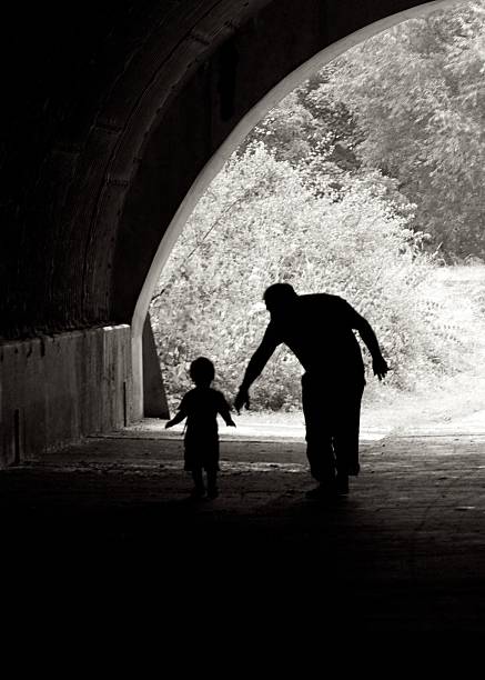 silhouettes in a tunnel stock photo