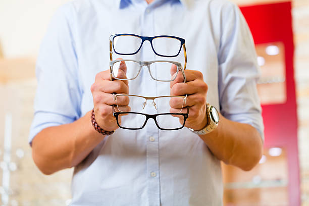 istock Young man at optician with glasses 466380393