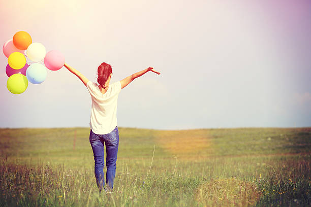 istock young asian woman   with colored balloons 466384954