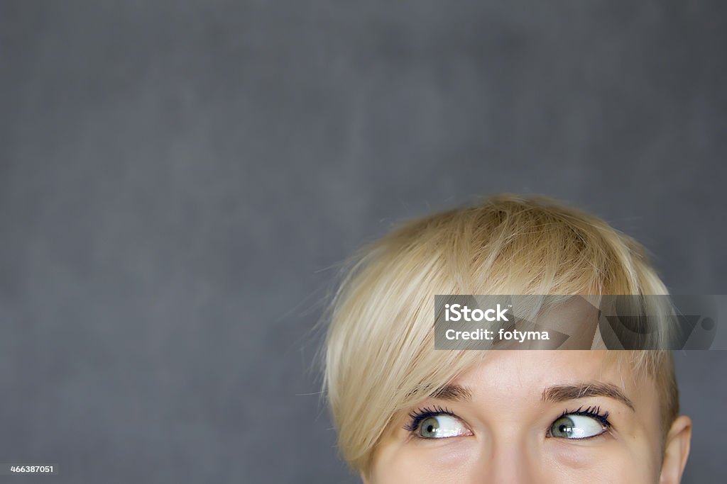 woman looking aside young woman looking aside against grey background Adult Stock Photo