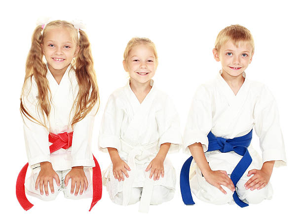 istock Children with a smile sitting in a ritual pose karate 466387795