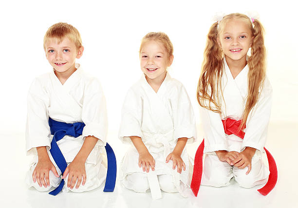 istock Cheerful athletes in kimono sitting in a karate pose ritual 466387811