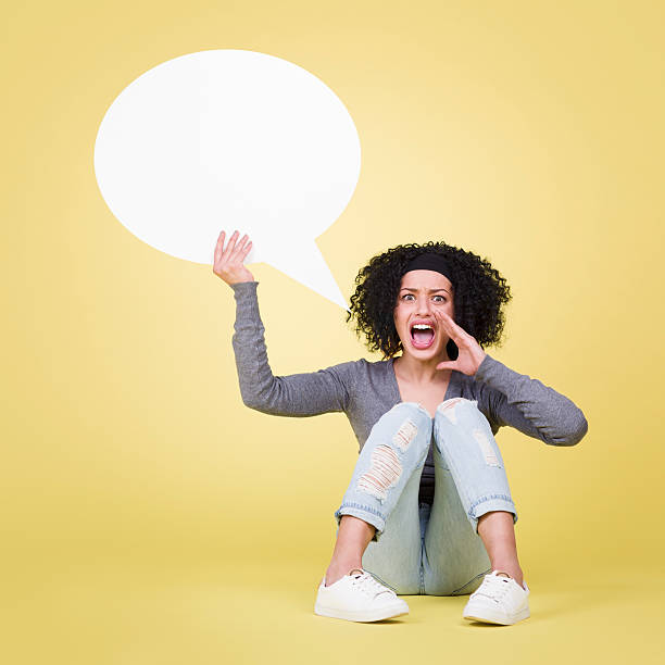 istock Angry girl screaming and holding empty speech balloon. 466388714