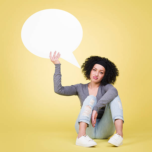 istock Upset girl holding a white speech balloon with copyspace. 466388718