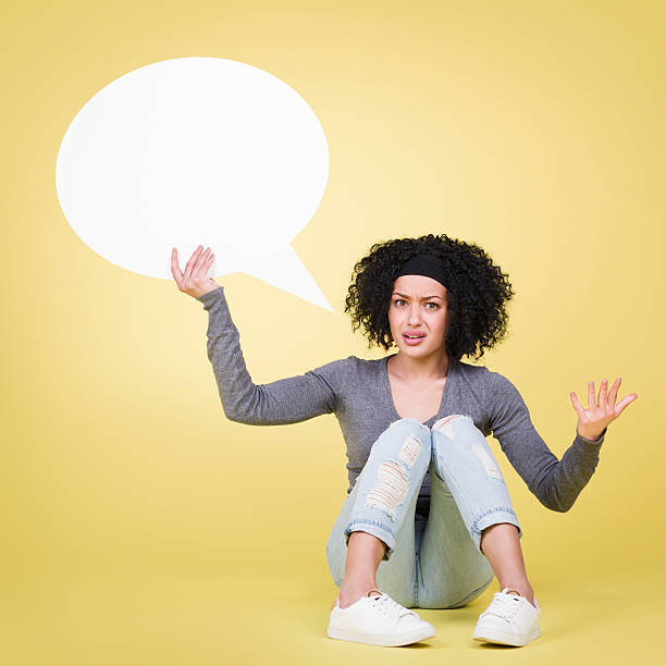 istock Annoyed girl holding white speech balloon with copyspace. 466388726