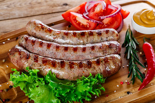 istock grilled sausages on the grill on the board 466389622
