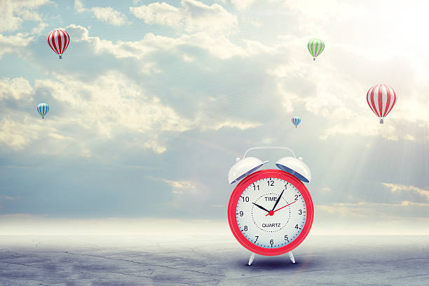 istock Alarm clock on concrete floor with background of clouds, hot 466390258