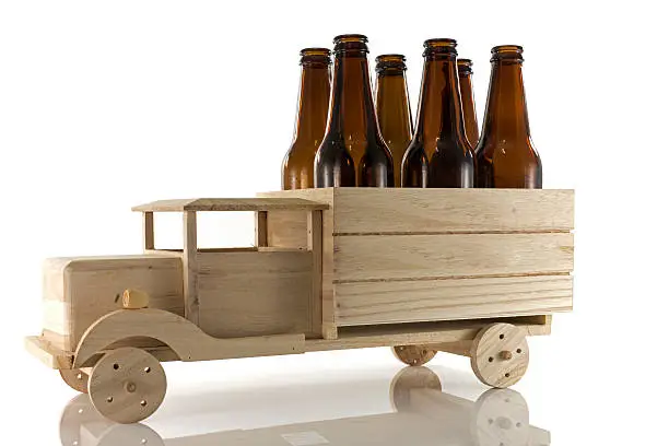 wooden car with beer bottles isoalted on white