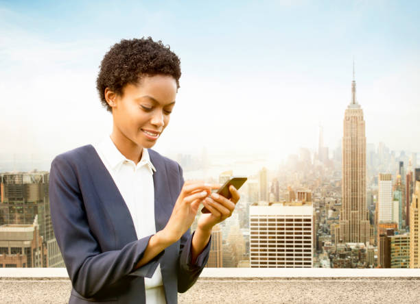 istock Businesswoman using smart phone in New York 466394658