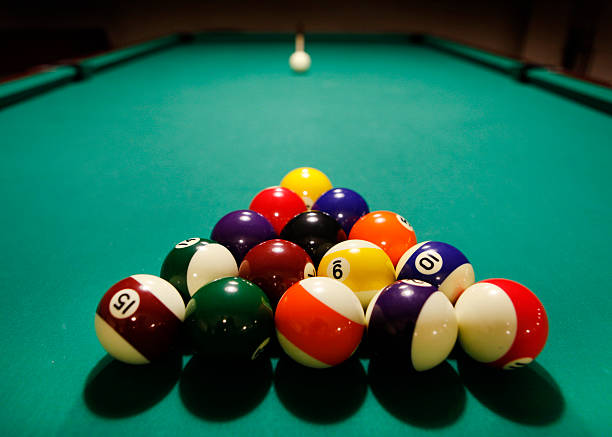 istock Color balls in triangle, aiming at cue ball 466394948