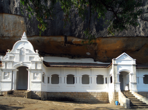 Dambulla, Matale District, Central Province, Sri Lanka: Golden Temple of Dambulla under a rock slab - Dambulla cave temple - Temple frontage - UNESCO World Heritage Site - photo by M.Torres