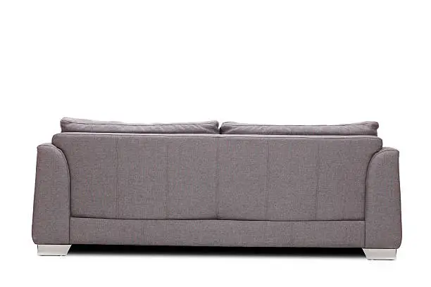 Rear view studio shot of a modern gray sofa isolated on white background