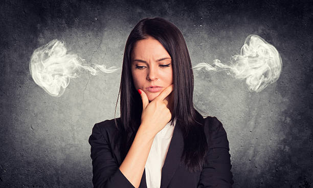 istock Thoughtful woman with steam from ears. Concrete gray as backdrop 466398780