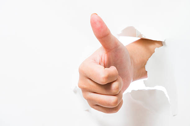 istock Thumb up hand gesture break through the paper wall 466399322