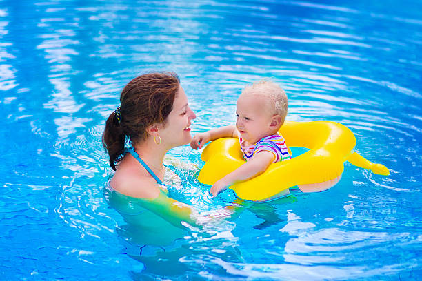 istock A mom and baby swimming in a pool 466399516