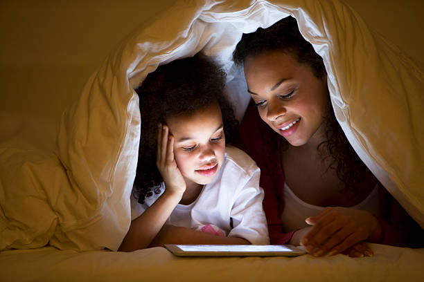 istock Mother and Daughter lying in bed 466399601