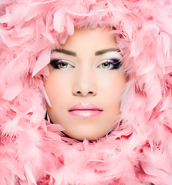 istock woman portrait and pink feathers 466399659