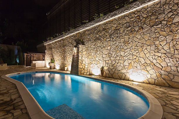 Modern outdoor private swimming pool at night stock photo