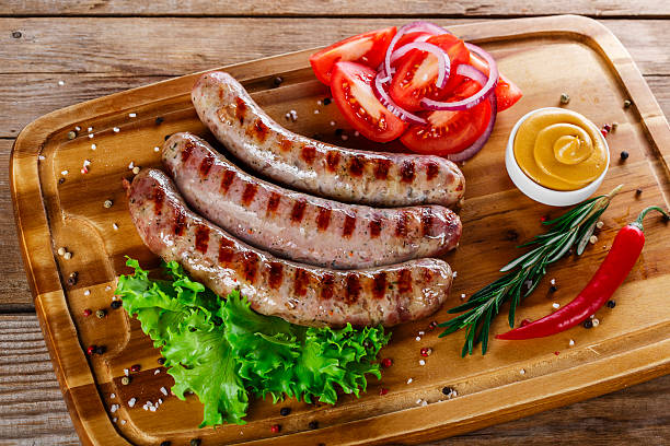 istock grilled sausages on the grill on the board 466400604