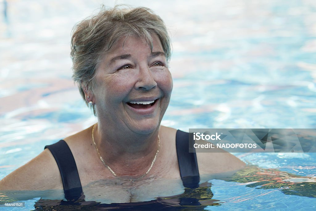 Senior woman swimming at the pool Swimming Stock Photo