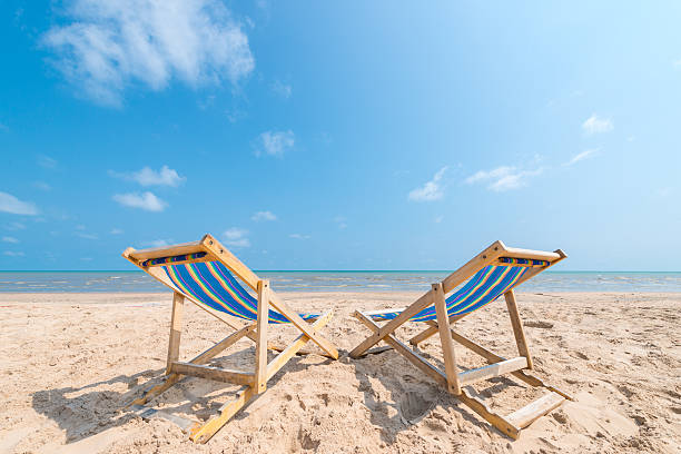 istock Couple of chairs on sandy beach on sunny day 466401628