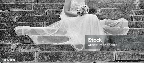 Beautiful Bride With Bouquet Sitting On Stairs Stock Photo - Download Image Now - 2015, Adult, Adults Only