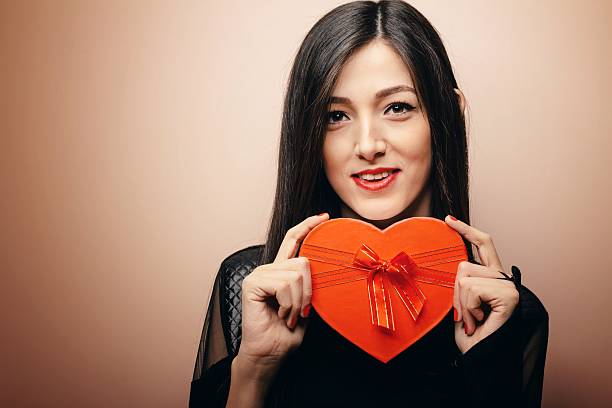 istock Happy young girl with heart gift box 466409107