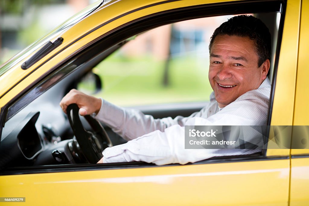 Happy taxi driver Happy taxi driver driving a car and smiling Taxi Driver Stock Photo