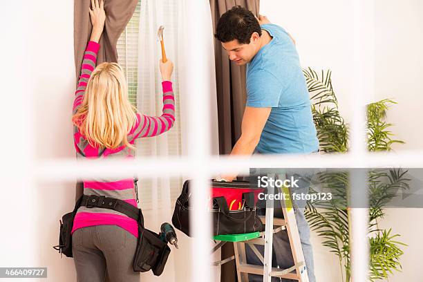 Construction Couple Installs Curtain In Home Tools Ladder Stock Photo - Download Image Now