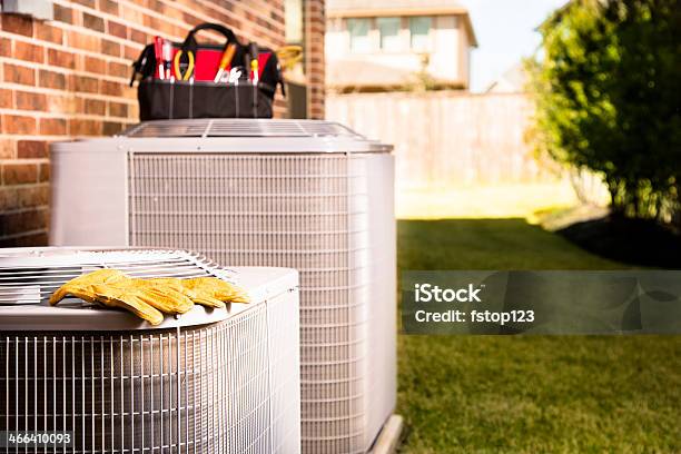 Service Industry Work Tools On Air Conditioners Outside Residential Home Stock Photo - Download Image Now